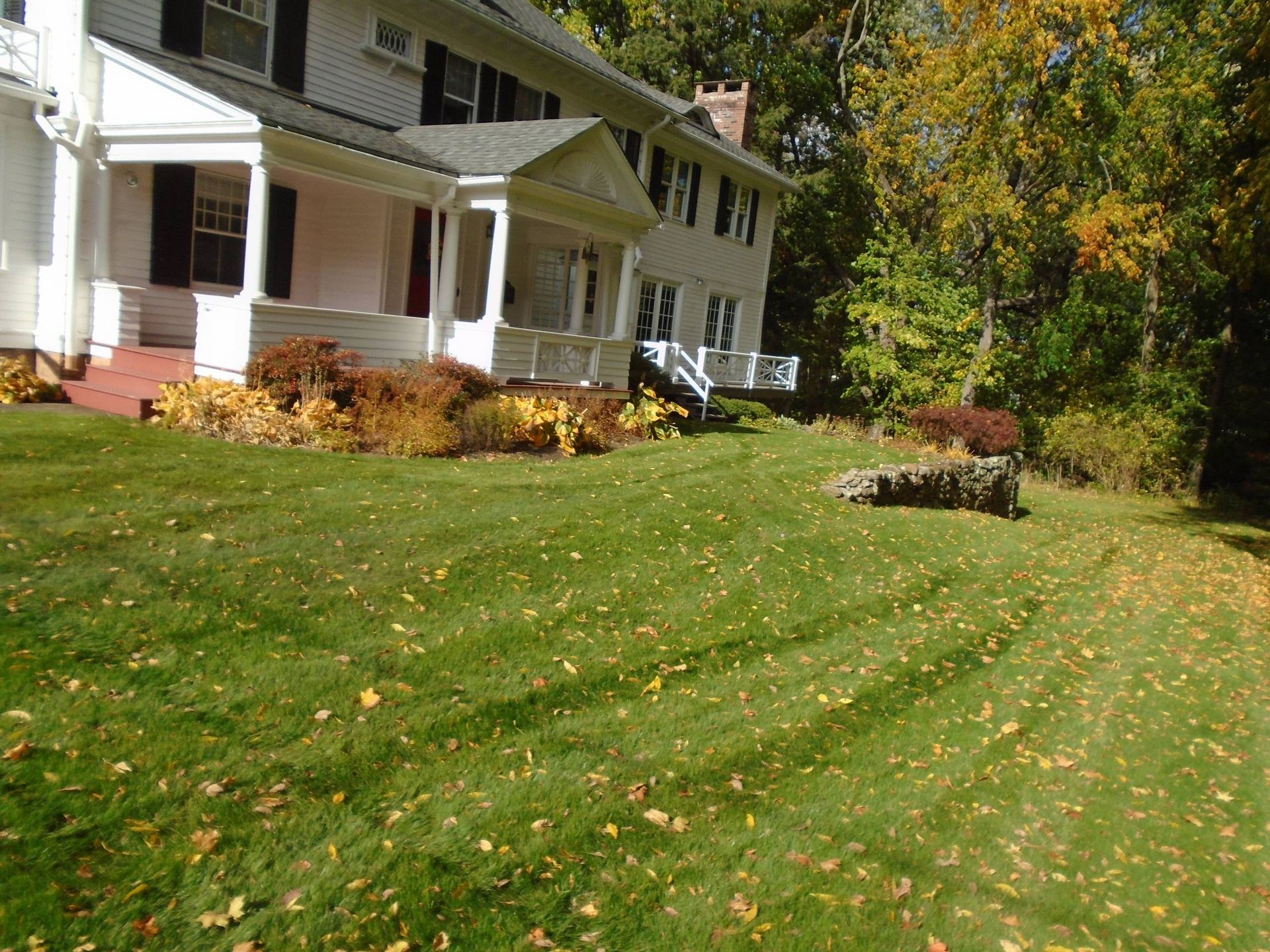 A large white house with a large lawn in front of it