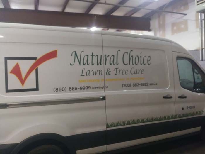 A white van that says natural choice lawn and tree care