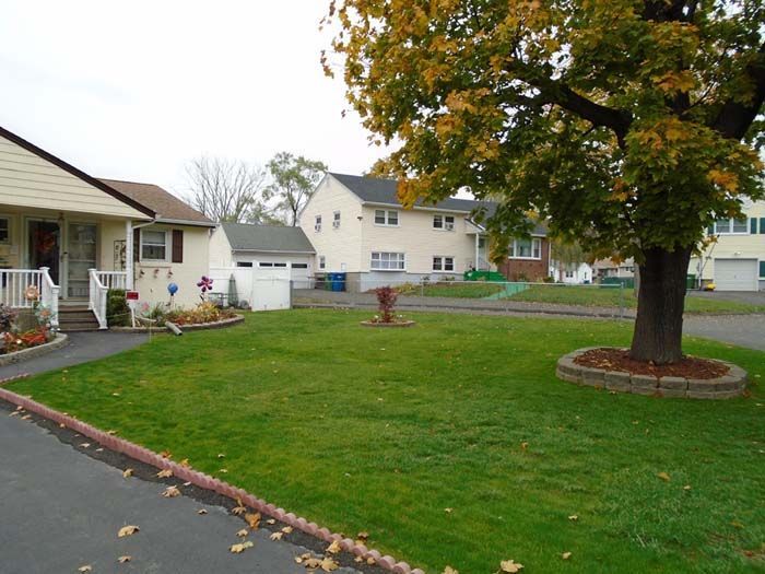 A house with a large lawn in front of it