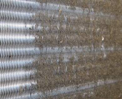 A close up of a radiator with a lot of dust on it.