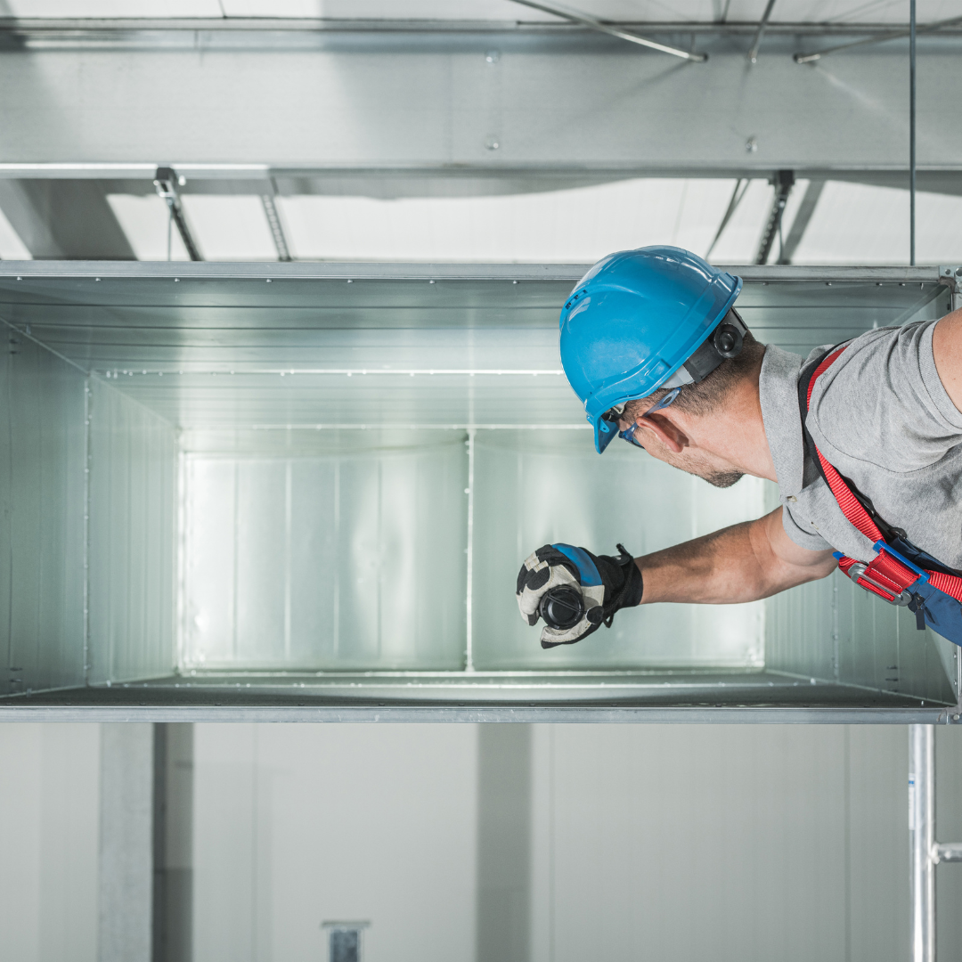 HVAC Tech investigating inside industrial HVAC system