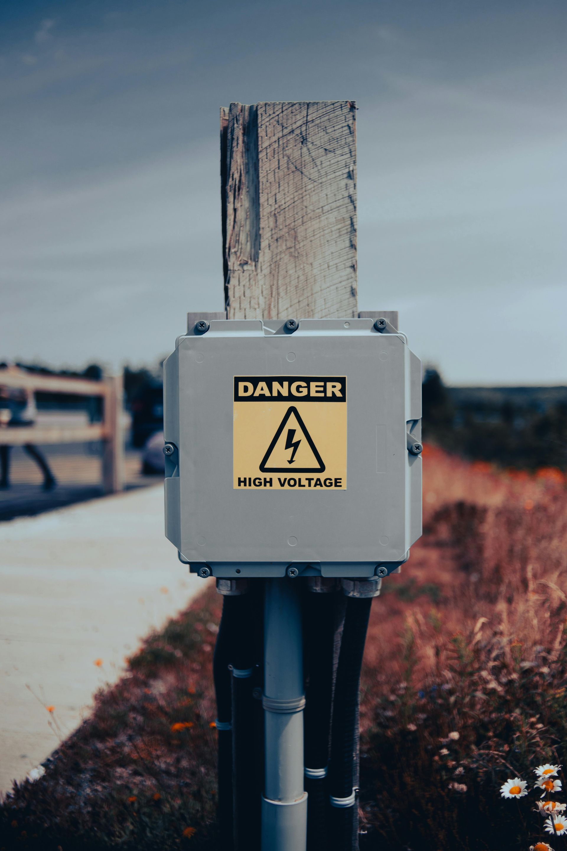 An electrical panel box on a pole.