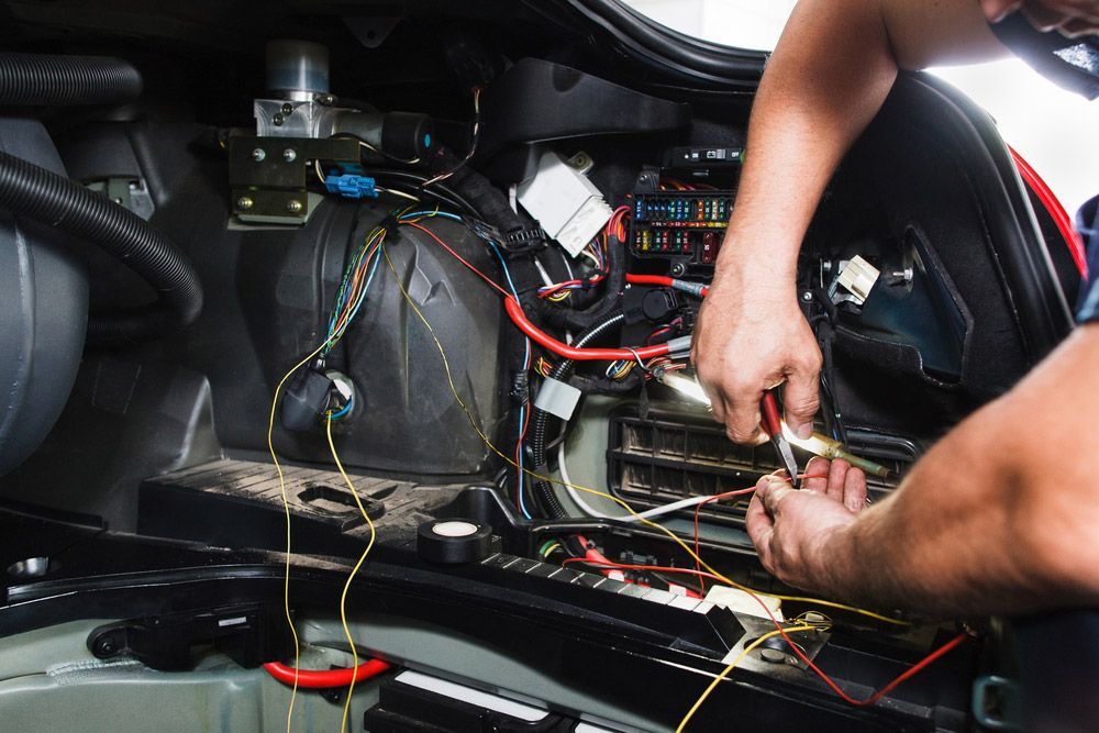 Electrician Works With Electric Block In Vehicle — Professional Marine Electrician In Tweed Heads, QLD