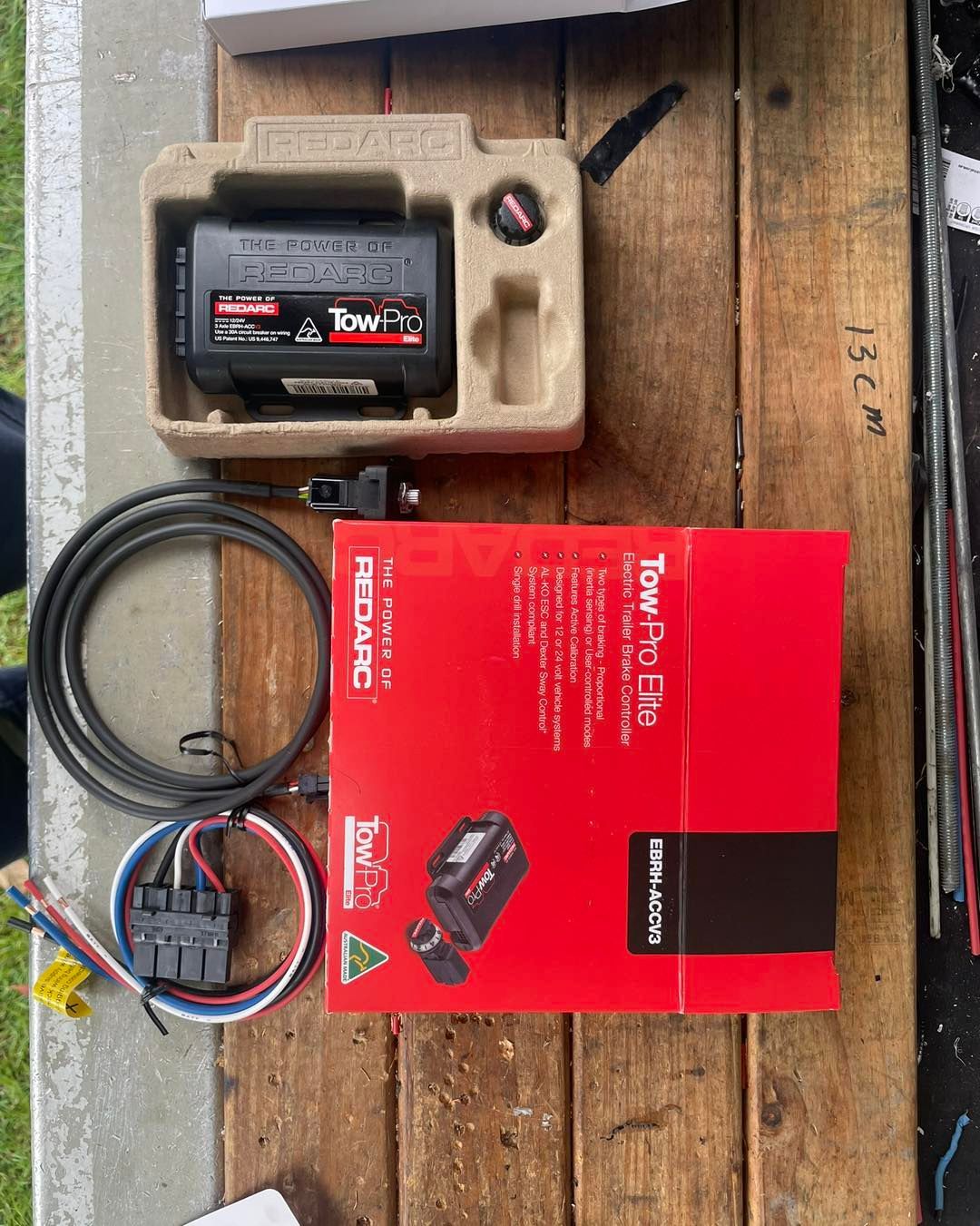 Tow-pro Elite Electric Trailer Brake Kit Components on a Wooden Surface — Glenn Rowe Auto Electrics In Coolangatta, NSW