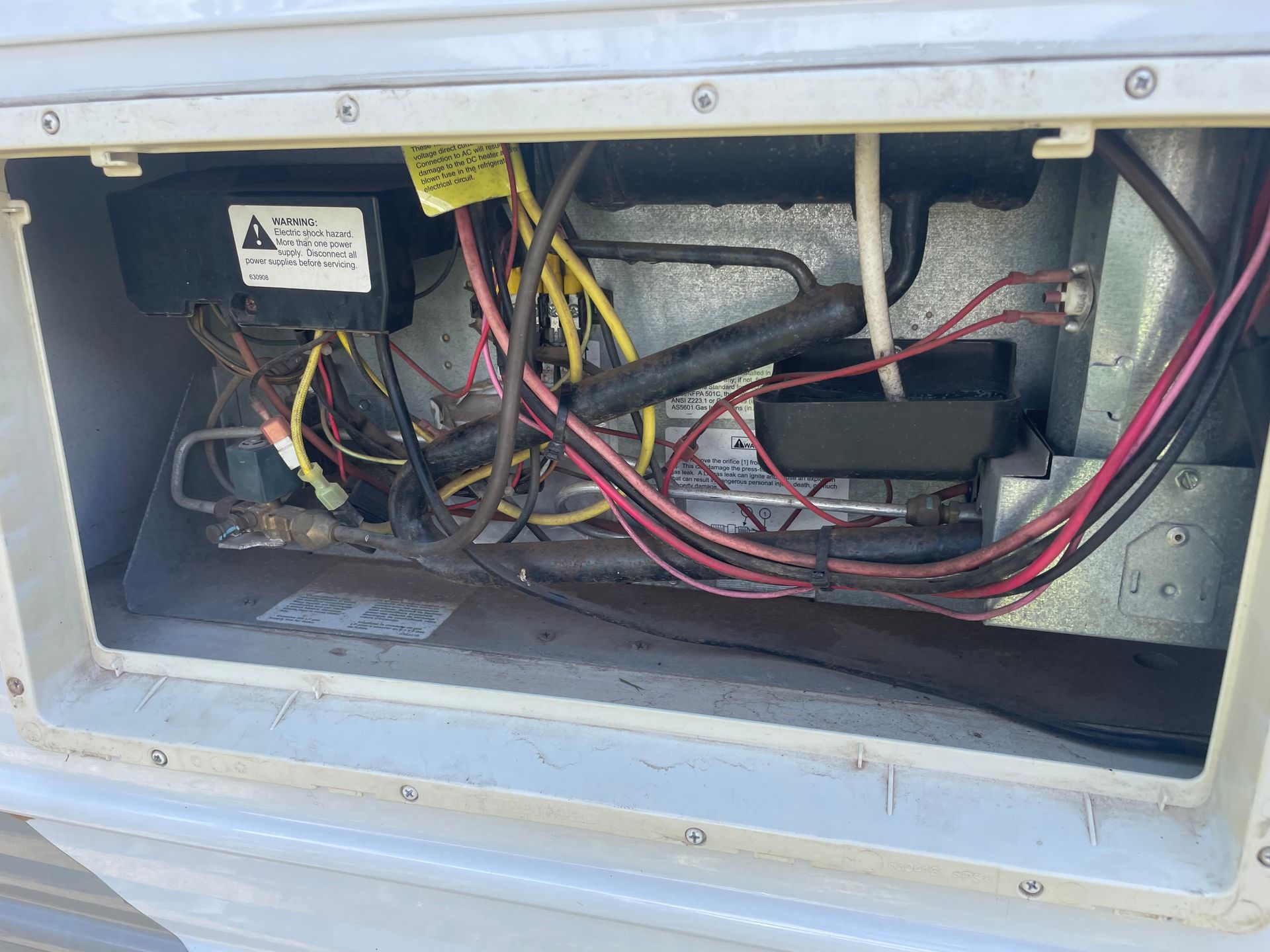 Open Compartment With Tangled Wires, Electrical Components — Glenn Rowe Auto Electrics In Palm Beach, QLD