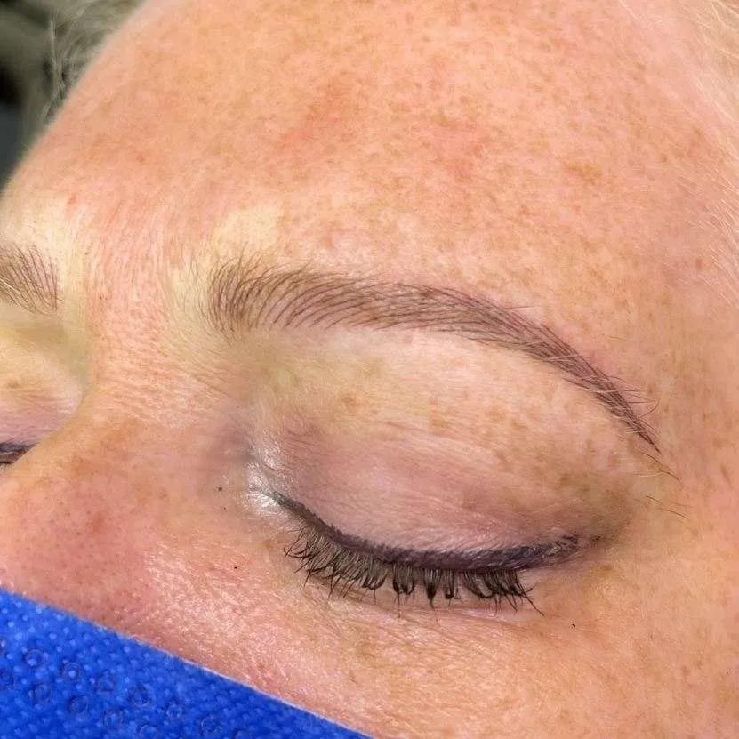 A close up of a woman 's face with her eyes closed.