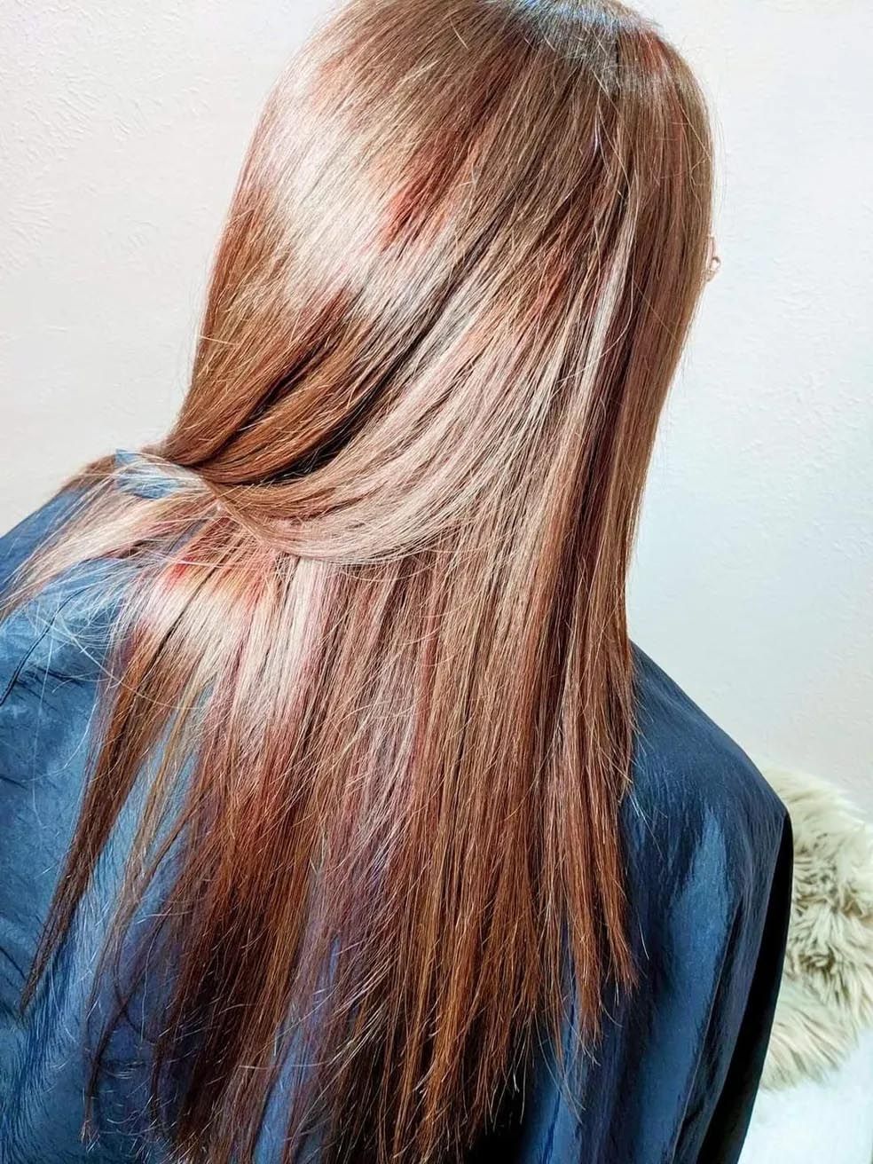 A woman with long brown hair is wearing a blue cape.