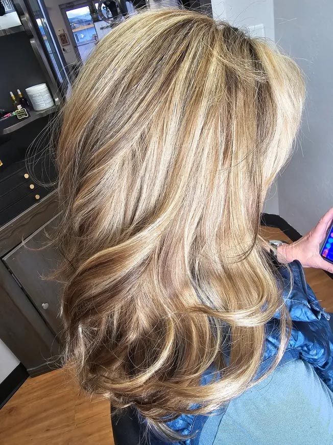 A woman is getting her hair done at a salon.