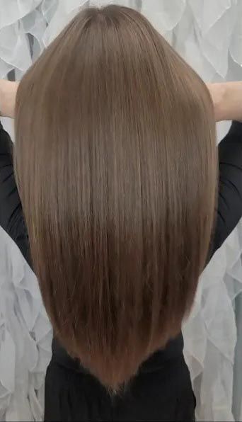 The back of a woman 's head with long brown hair.
