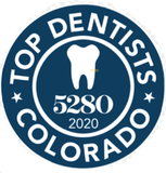 A logo for top dentists in colorado with a tooth in the center