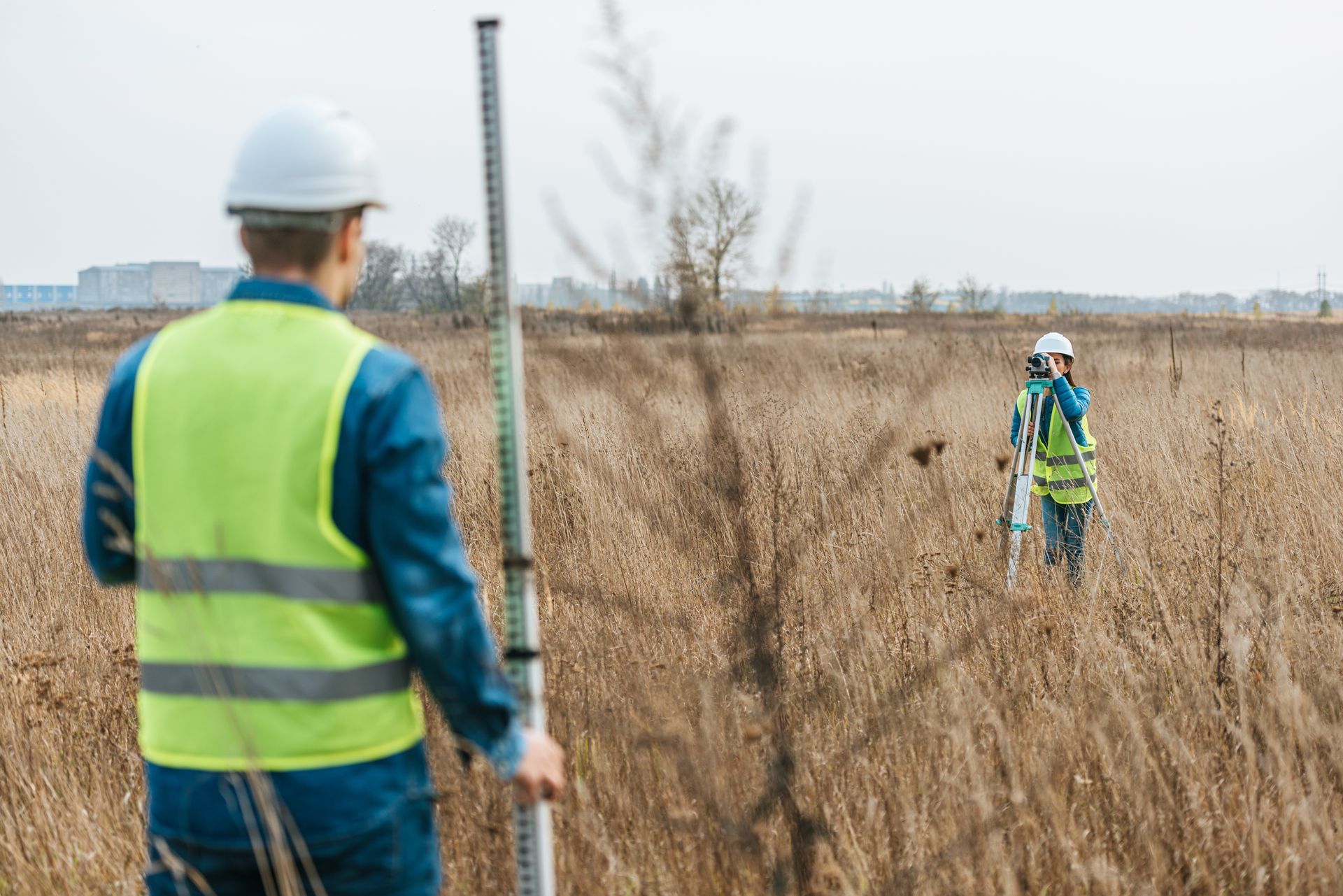 A group of surveyors is measuring a land.