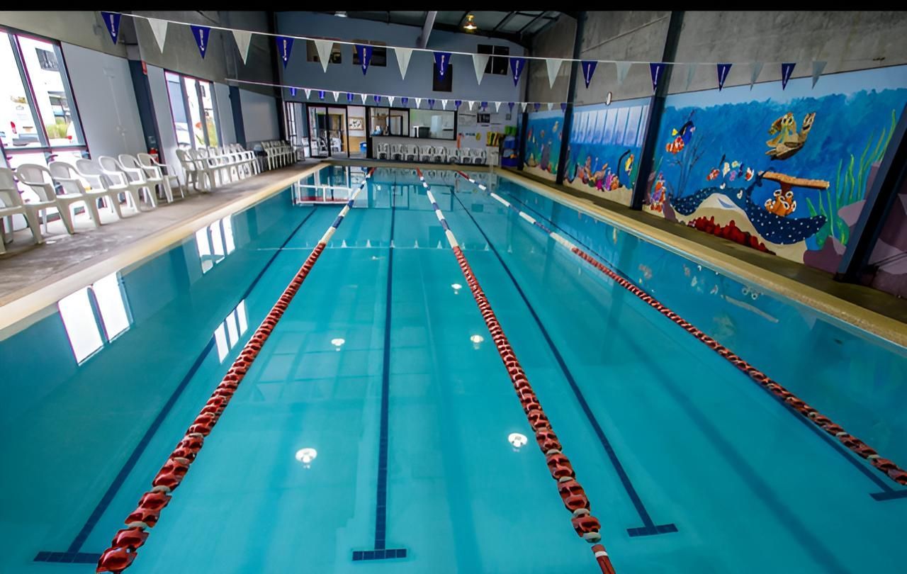 A Large Swimming Pool With a Mural on the Wall — North Wyong Aqua Centre In Wyong, NSW