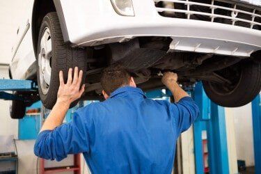 Man Aligning The Car Wheels — Wheel Alignment in Marion, NC