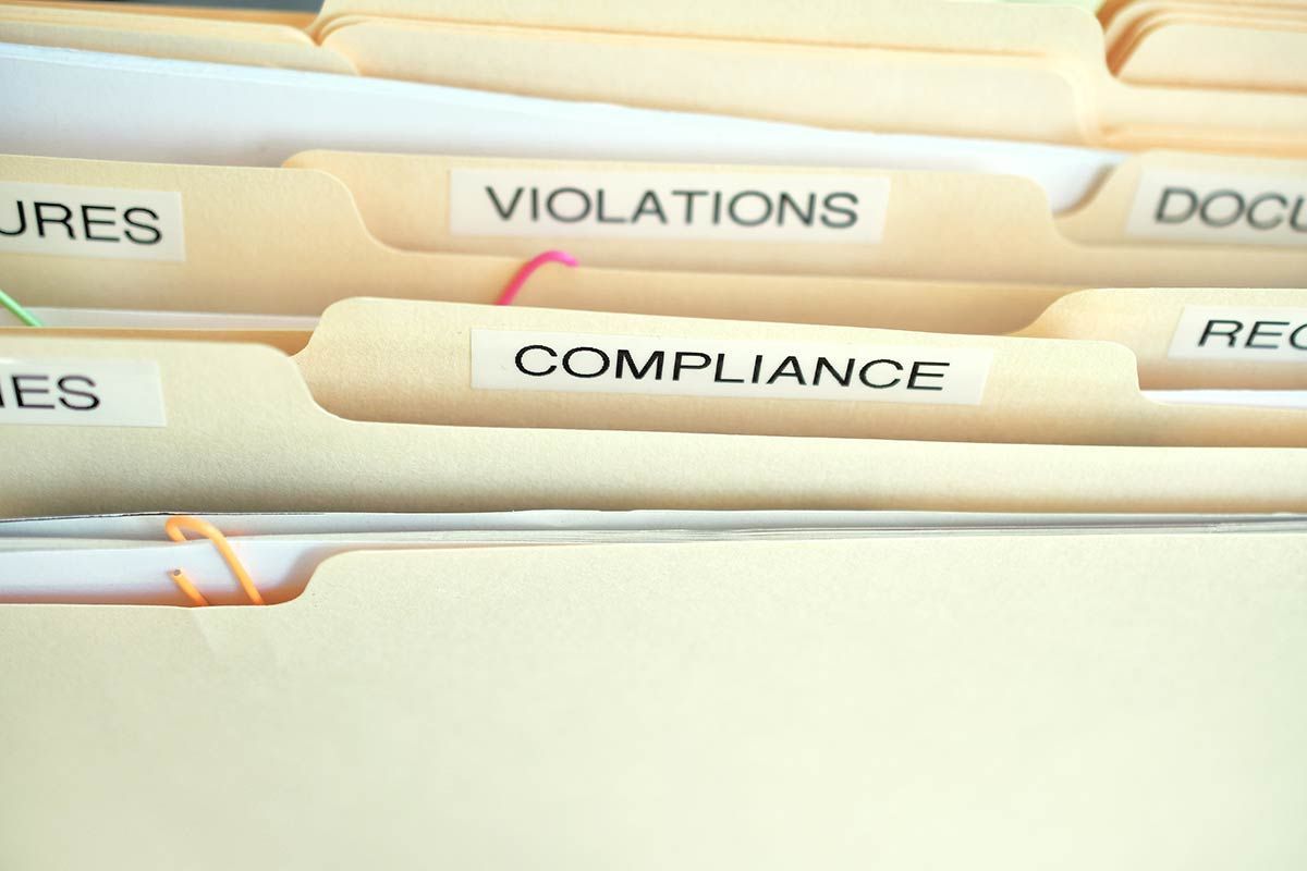 Compliance in the workplace. Folders labeled Compliance, Violations in focus