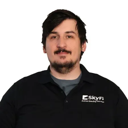 A man with a beard is wearing a black shirt with the word skyfi on it.