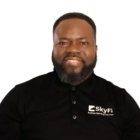 A man with a beard is wearing a black shirt with the word skyfi on it.