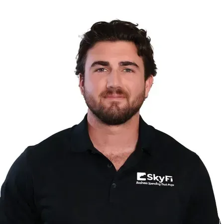 A man with a beard is wearing a black shirt with the word skyfi on it.