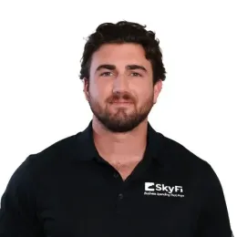 A man with a beard is wearing a black shirt with the word skyfi on it.