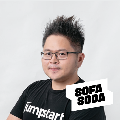 A man wearing glasses and a black shirt with the word jumpstart on it