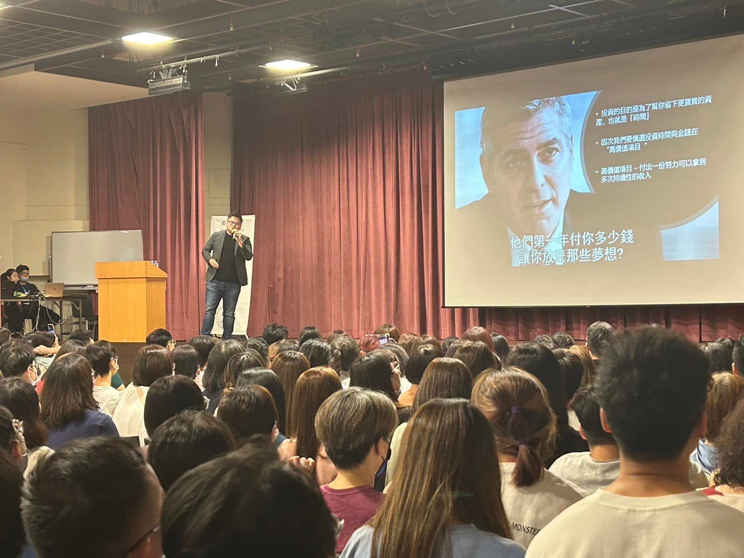 A man is giving a presentation to a large group of people.