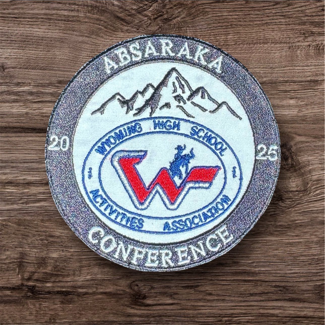 A round patch with the words absaraka wyoming high school activities association conference on it