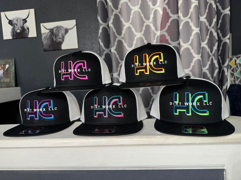 A row of hats with the word hc on them