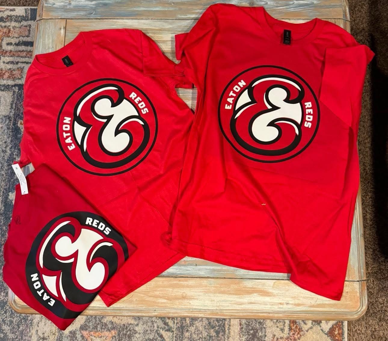 A couple of red shirts that say catch reds on them