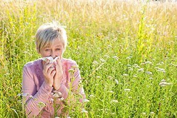 Senior woman with Handkerchief in the Grass — Asthma Disorders in White Plains, New York