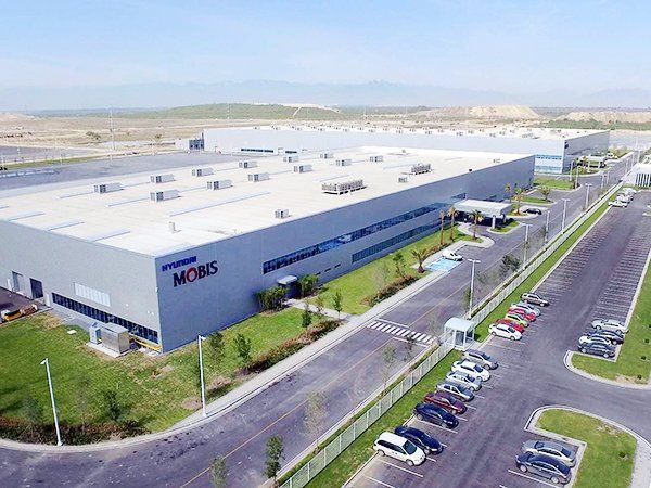 An aerial view of a large building with the word moms on it