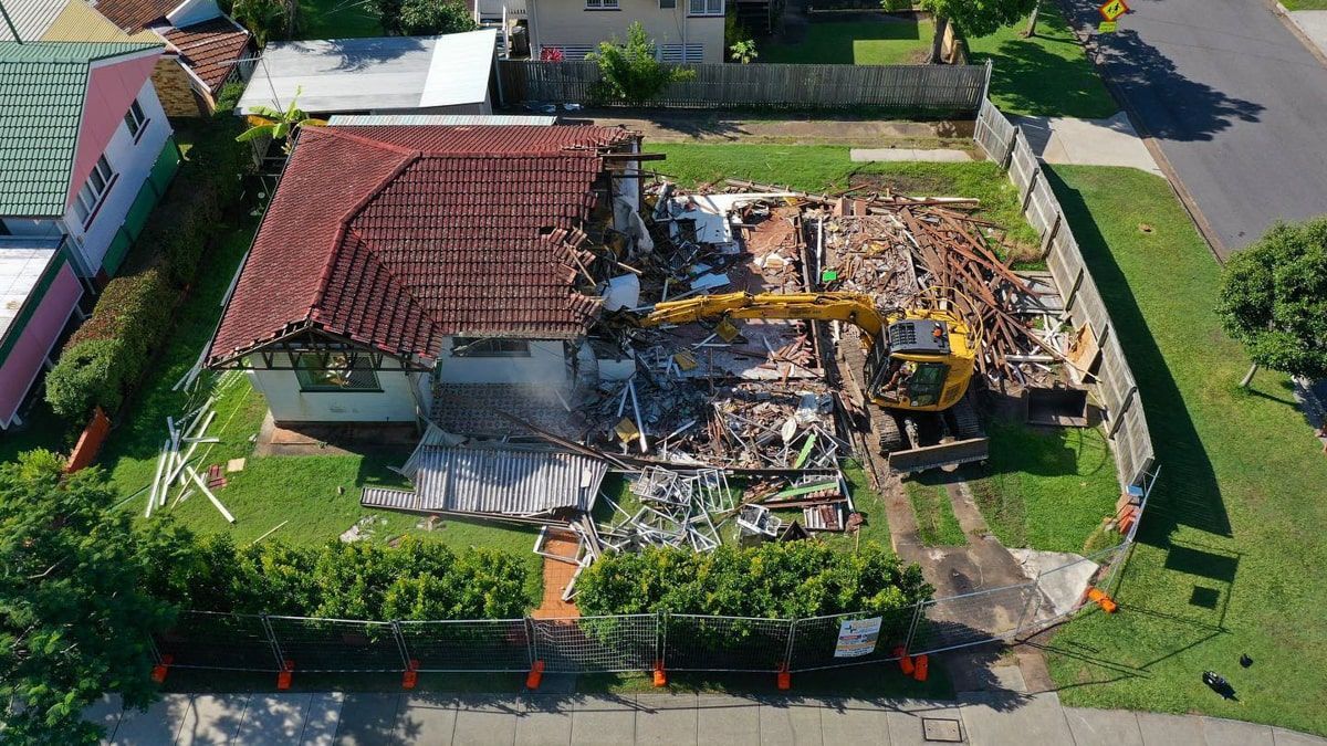An aerial view of a house being demolished.