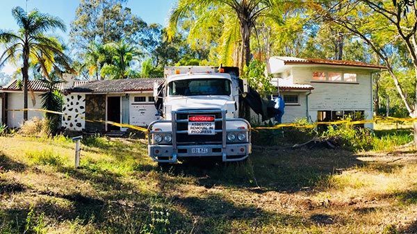 A white truck is parked in front of a house.