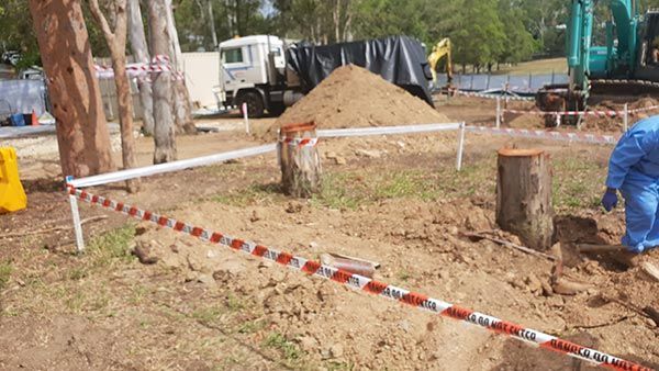 A man is digging in the dirt in a construction site.