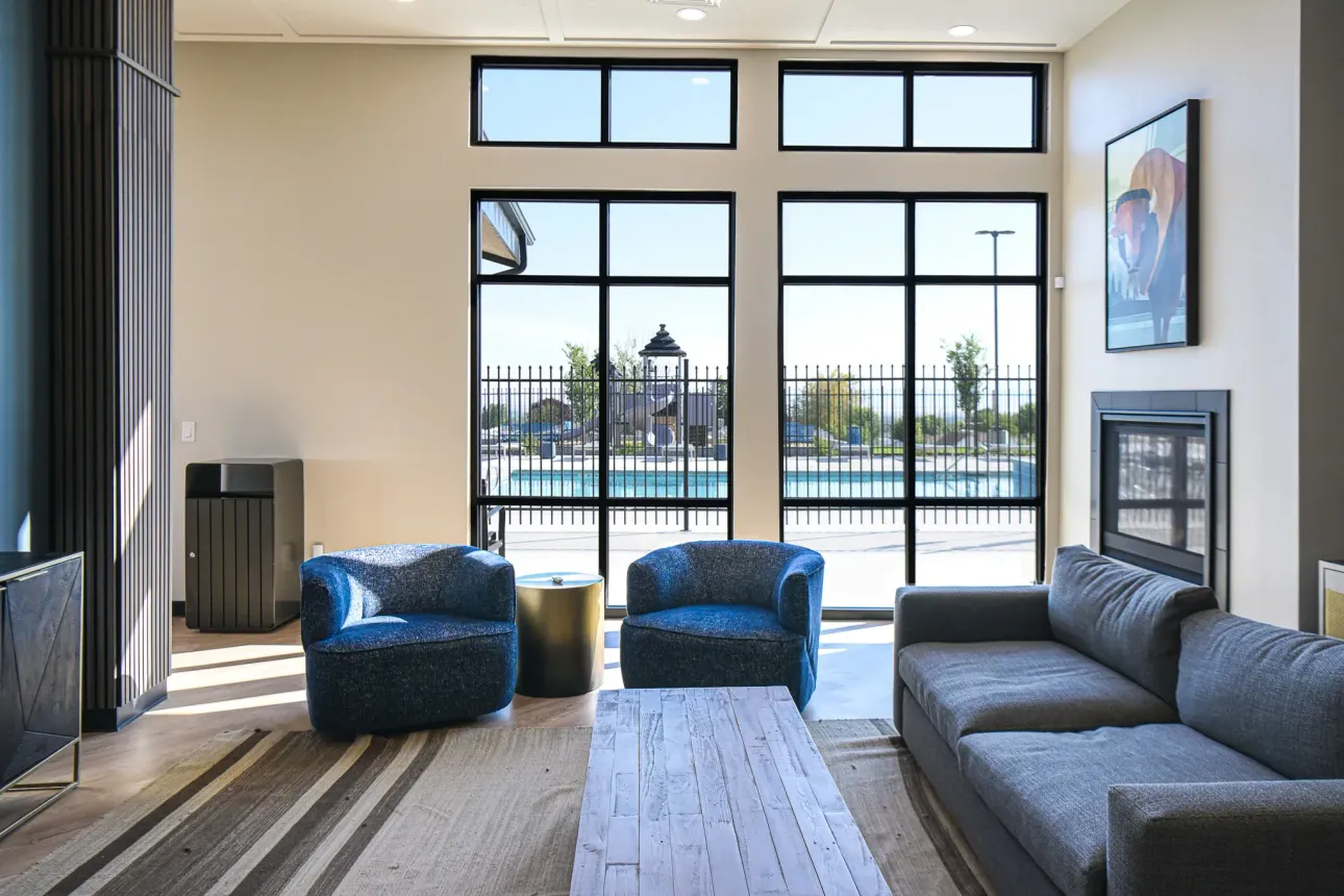 A living room with a couch , chairs and a table