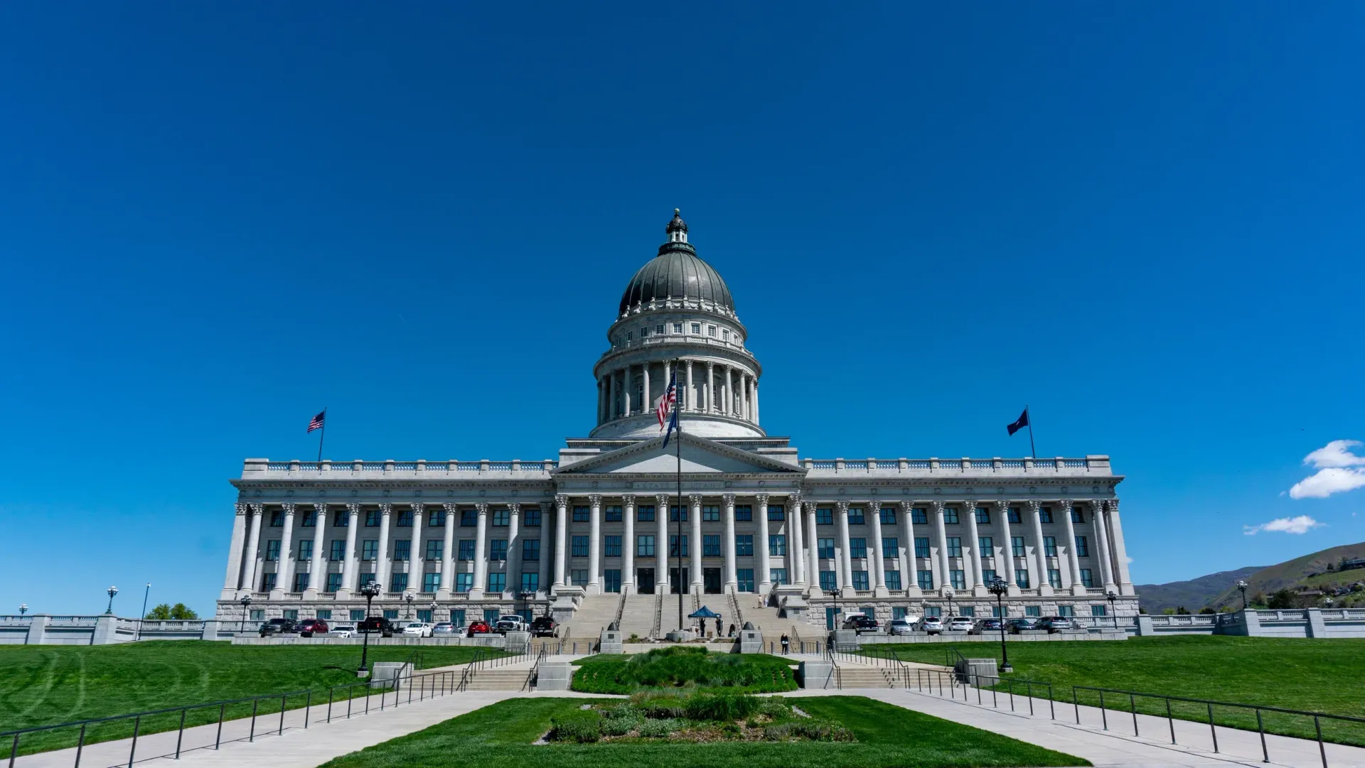 A large white building with columns and a dome on top of it.