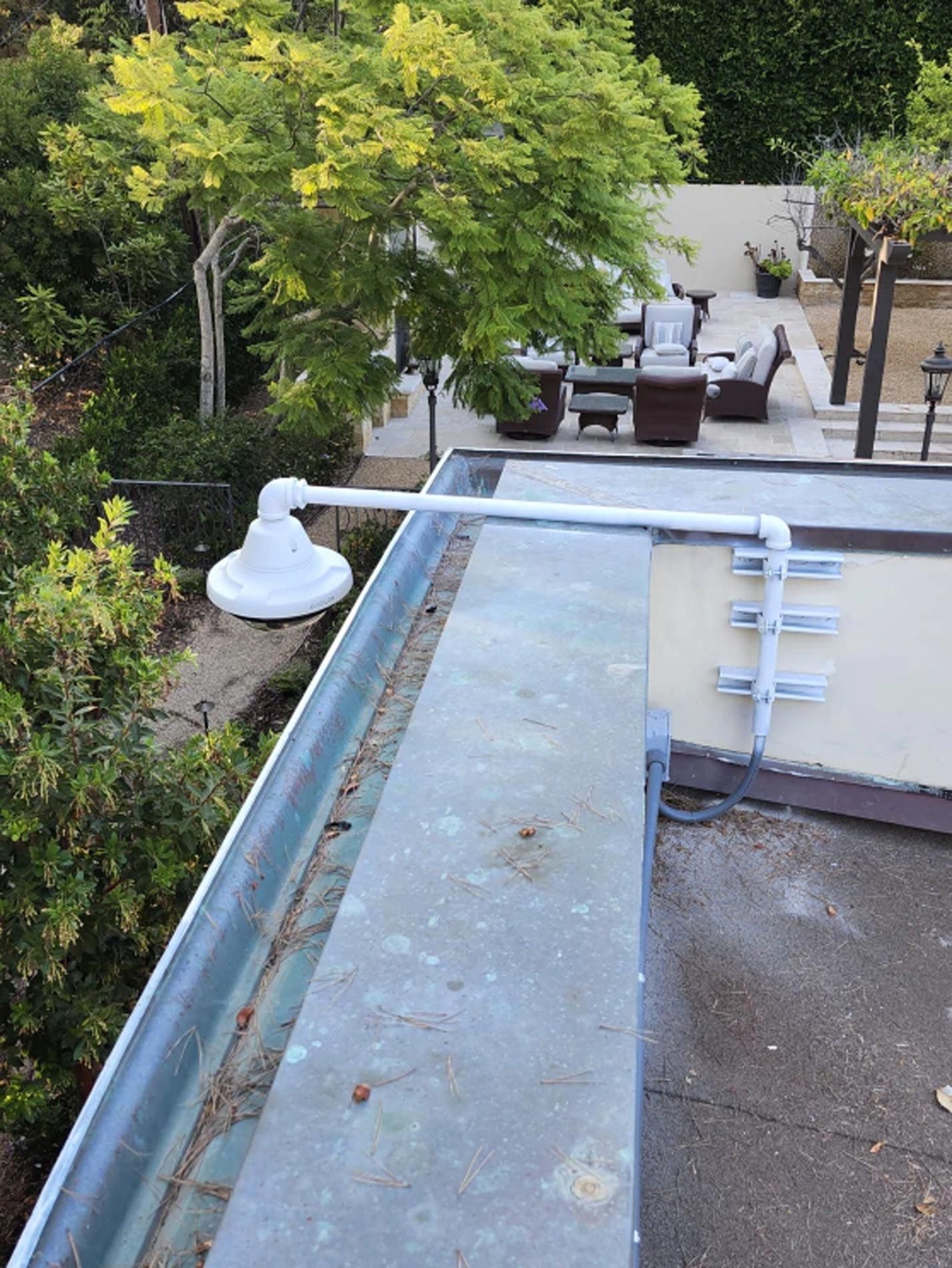 A white light is mounted on the side of a building.