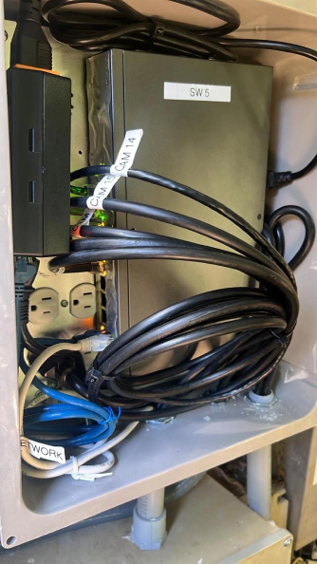 A bunch of wires are plugged into a box.