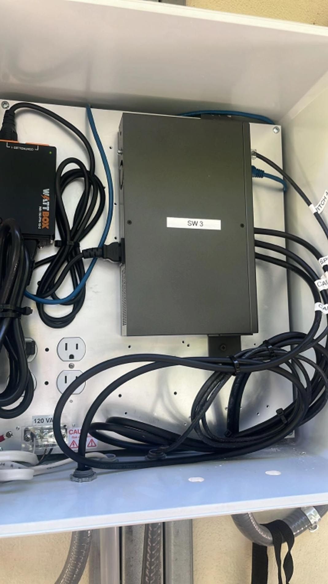 A box filled with lots of wires and electrical equipment.