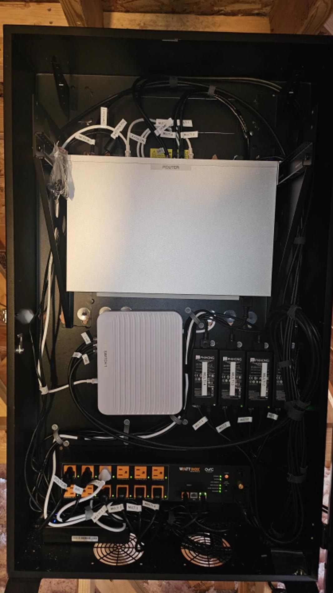 A black box with a lot of wires coming out of it.