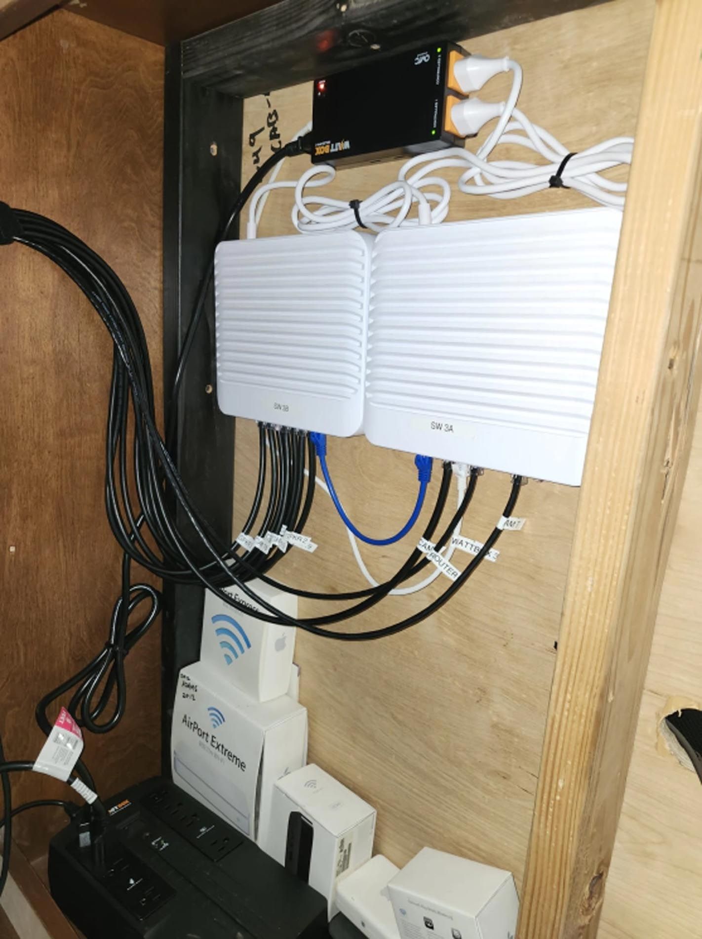 A cabinet with a lot of wires coming out of it
