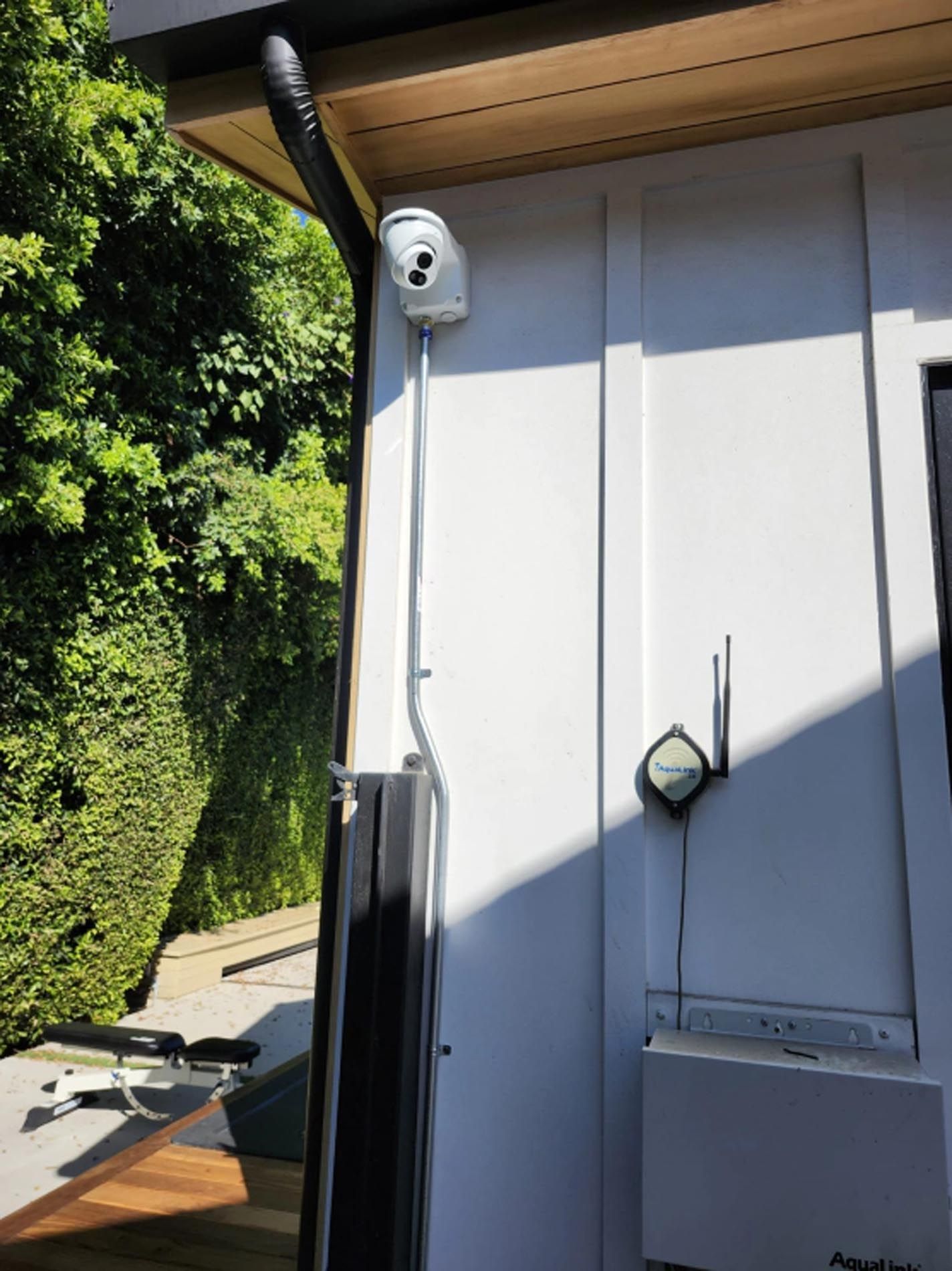 A security camera is mounted on the side of a building.