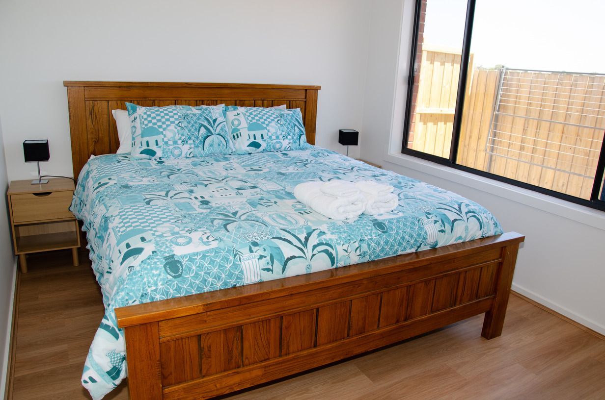 A bedroom with a king size bed and a window.