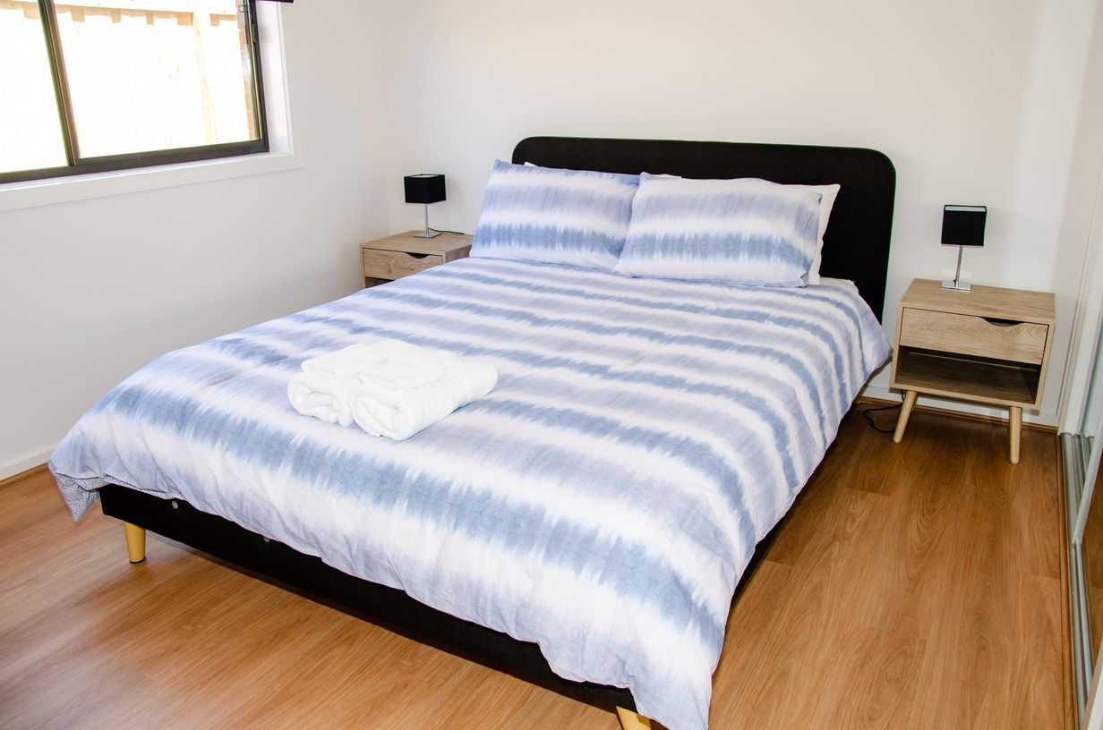 A bedroom with a king size bed and two nightstands