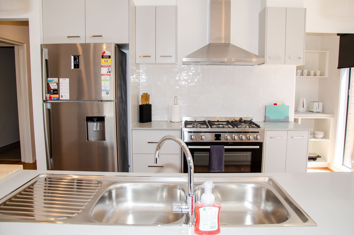 A kitchen with stainless steel appliances and a sink