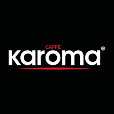 il logo del caffè karoma è bianco e rosso su sfondo nero .
