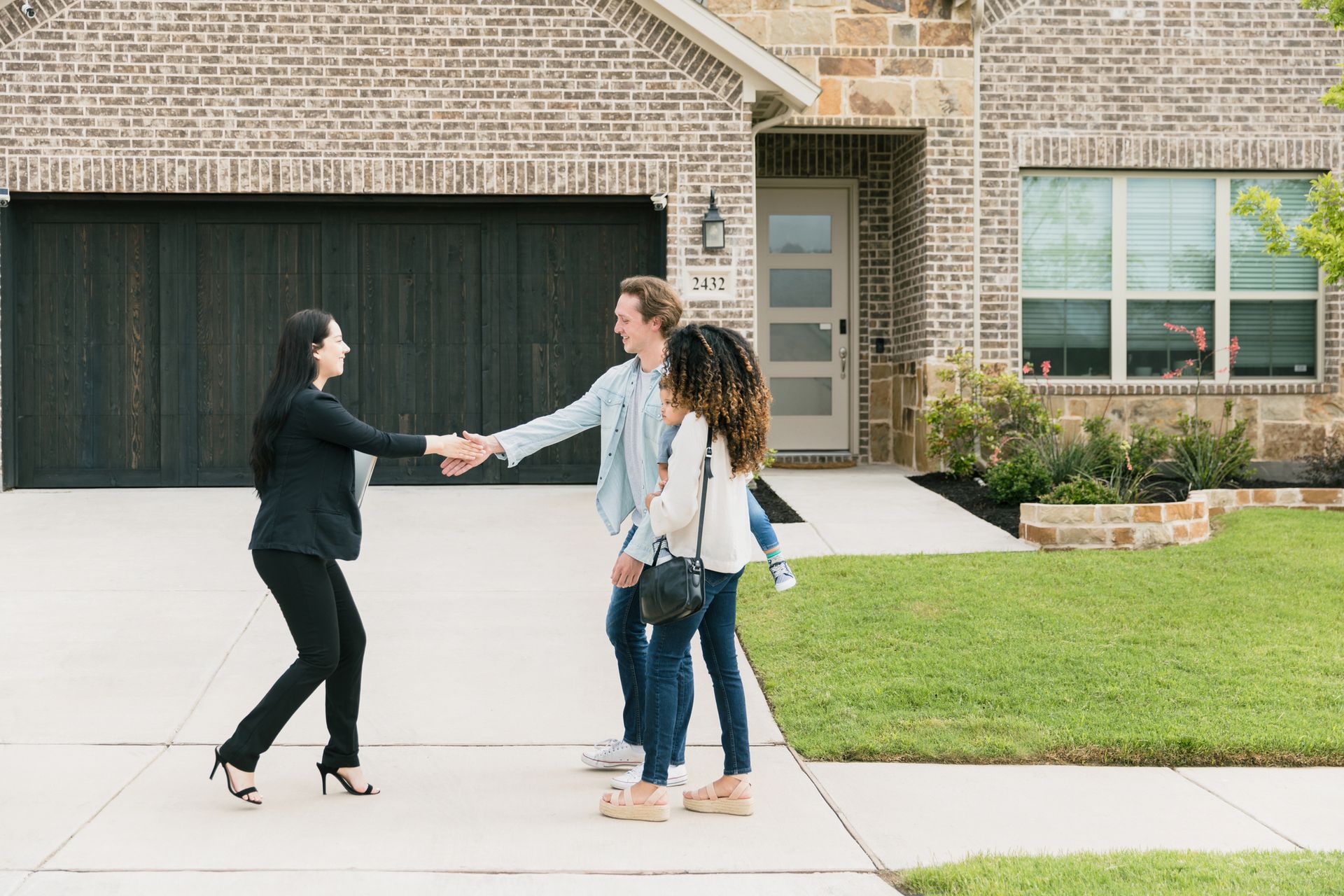 Female Real Estate Agent Shakes Hands With Couple – Morgantown, WV – O'connor Contracting