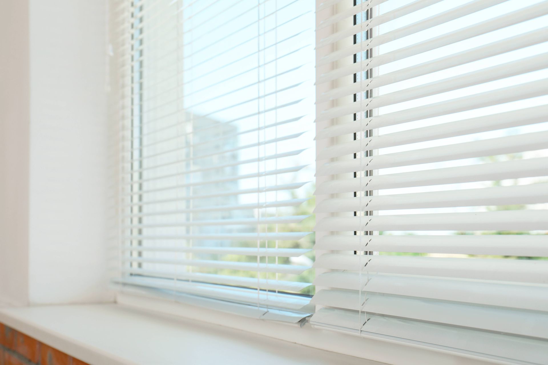 White modern blinds covering a set of windows in a California home at LC Window Treatments near Sono