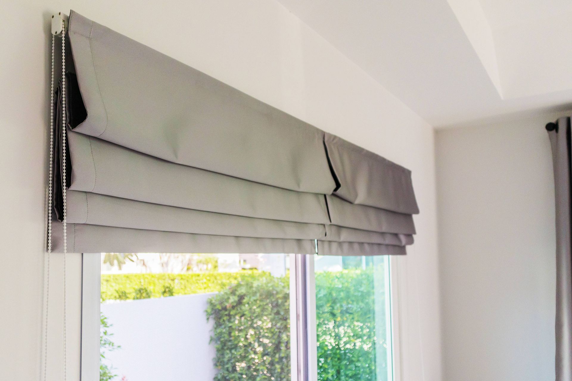 Custom fabric shades hanging on a set of sliding glass doors at LC Window Treatments near Sonoma, CA