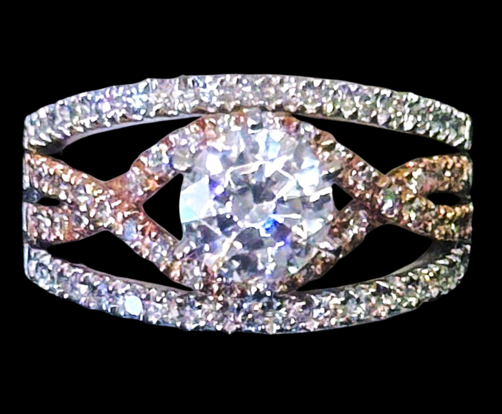 Diamond ring with a large center stone, set in a two-tone rose and white gold band, encrusted with diamonds.