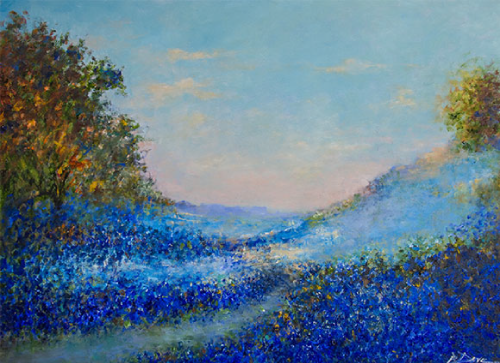 Bluebonnet field in Texas landscape, trees on sides, light blue sky.