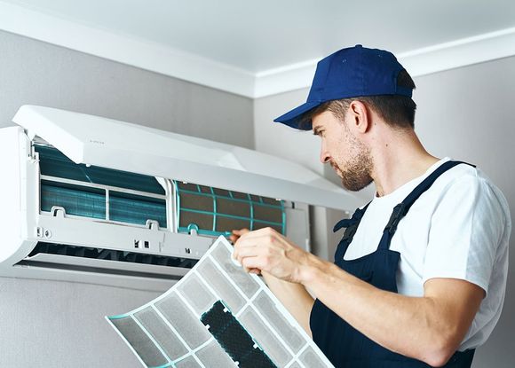 Man Cleaning Air Conditioner — Polk County, FL — Randolph’s AC/Heating